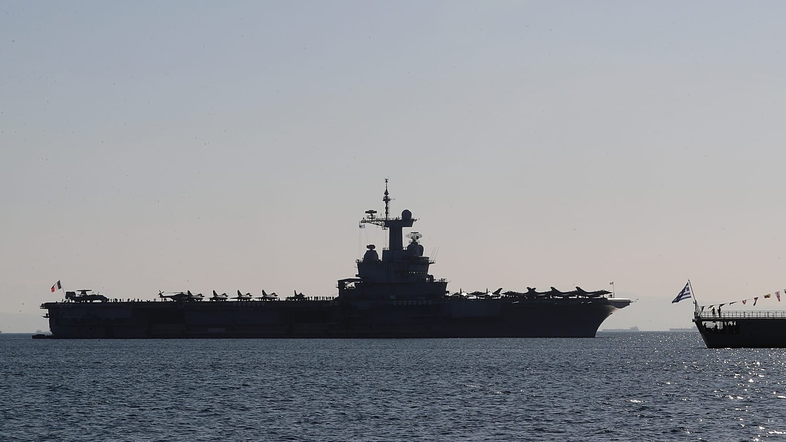 The Charles de Gaulle aircraft carrier is seen off the shore of the Faliro suburb, in Athens, Greece, Thursday, March 24, 2022.