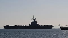 The Charles de Gaulle aircraft carrier is seen off the shore of the Faliro suburb, in Athens, Greece, Thursday, March 24, 2022.