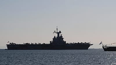 The Charles de Gaulle aircraft carrier is seen off the shore of the Faliro suburb, in Athens, Greece, Thursday, March 24, 2022.