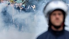 Protesters clash with riot police during a national demonstration against government budget cuts