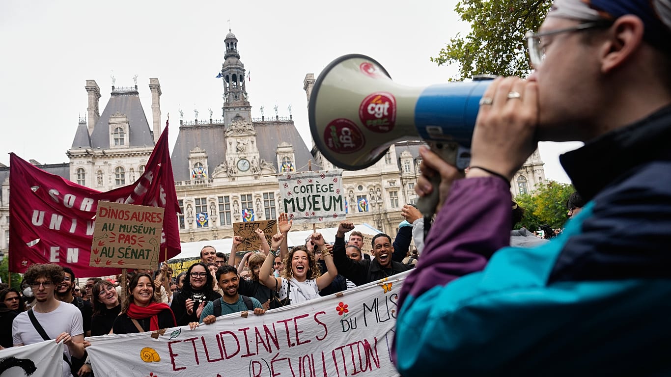 Students gather behind a banner reading:" Students for (R)Evolution," before a march to protest against under-resourced schools in Paris, 13 October 2026.