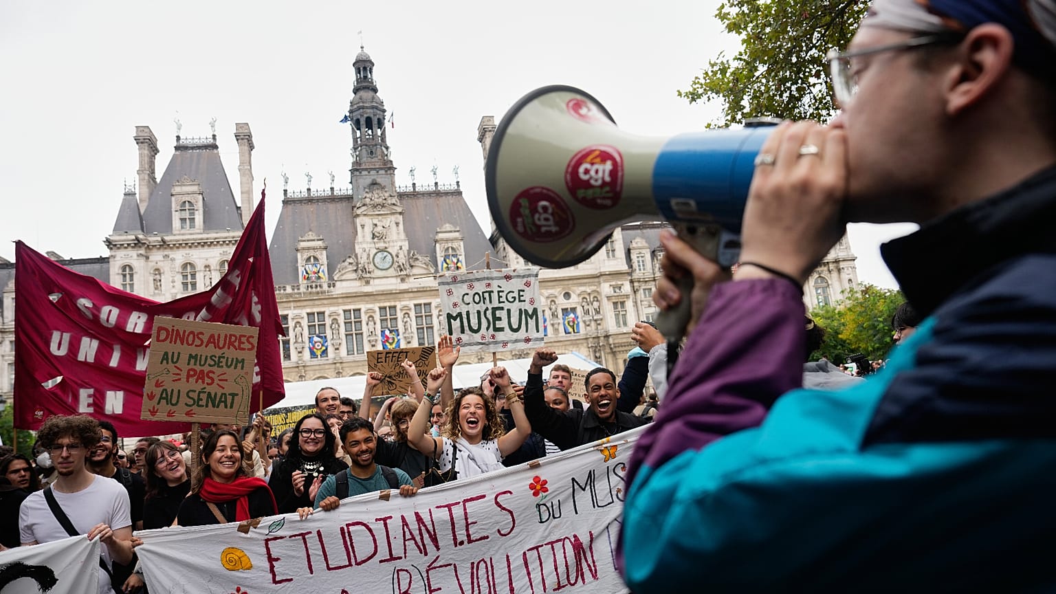 Students gather behind a banner reading:" Students for (R)Evolution," before a march to protest against under-resourced schools in Paris, 13 October 2026.