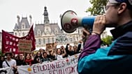 Students gather behind a banner reading:" Students for (R)Evolution," before a march to protest against under-resourced schools in Paris, 13 October 2026.