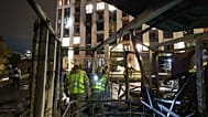 Police officers search for fragments of a Shahed drone in front of a residential building in Kyiv, 12 October, 2026