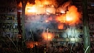 A damaged multi-storey residential building is seen on fire after a Russian missile strike on Kyiv, 13 October, 2026