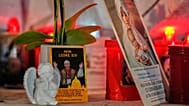 An image of Pope Leo XIV rests at the base of a statue of the late Pope John Paul II outside the Agostino Gemelli Polyclinic in Rome, 13 October, 2026