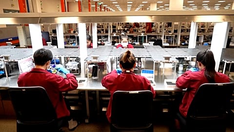 Workers making jewellery in Pandora's new factory