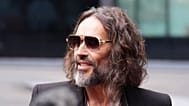 Russell Brand speaks to the media as he arrives at Southwark Crown Court in London, 14 October, 2026