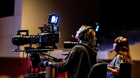 Production crew operating a camera rig