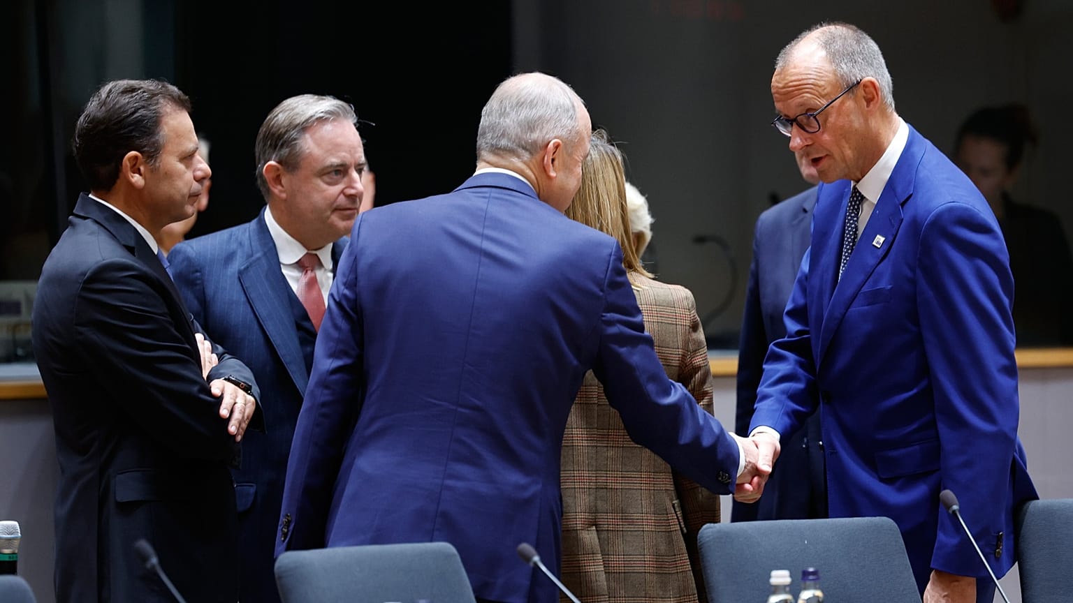 French President Emmanuel Macron, center, speaks with European Commission President Ursula von der Leyen during a round table meeting at the EU summit in Brussels, 15 October.