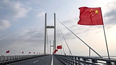 Chinese flags are flown during the opening ceremony of the new China-North Korea Yalu River Bridge, 15 October, 2026