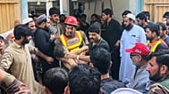 A rescue worker carries an injured child after rescuing him from the rubble of a roof collapse at a private school in Peshawar, 15 October, 2026