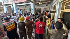 Rescue workers and volunteers take part in the rescue operation at the site of a roof collapse at a private school in Peshawar, 15 October, 2026