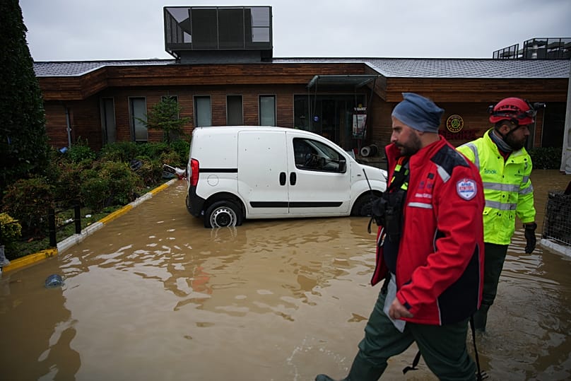 Emergency team members work in the aftermath of floods caused by heavy rains in Istanbul, 15 October, 2026