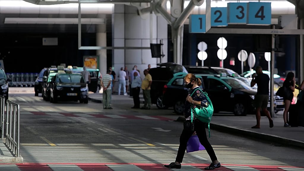Passengers wait for airport taxis