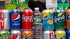 File - Cans of soda and bottled water are displayed on a food cart, Monday, 7 May 2018 in New York. 