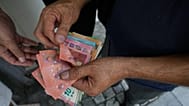 FILE. A money exchanger counts Euro bank notes, 24 Aug. 2026