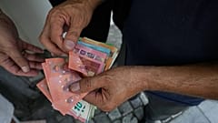 FILE. A money exchanger counts Euro bank notes, 24 Aug. 2026