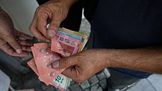 FILE. A money exchanger counts Euro bank notes, 24 Aug. 2026