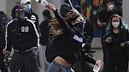 A young protester throws a plastic bottle towards riot police during clashes in Tirana, Albania, Thursday, 15 Oct., 2026, as students joined an anti-government demonstration. 