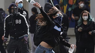 A young protester throws a plastic bottle towards riot police during clashes in Tirana, Albania, Thursday, 15 Oct., 2026, as students joined an anti-government demonstration. 