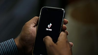 Un homme ouvre l'application de réseaux sociaux « TikTok » sur son téléphone portable. (Image d'illustration)