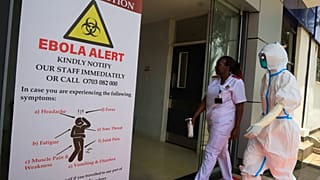 Health workers and officials walk outside a Ebola isolation facility at The Nairobi Hospital, Kenya, Wednesday, Oct. 7, 2026.
