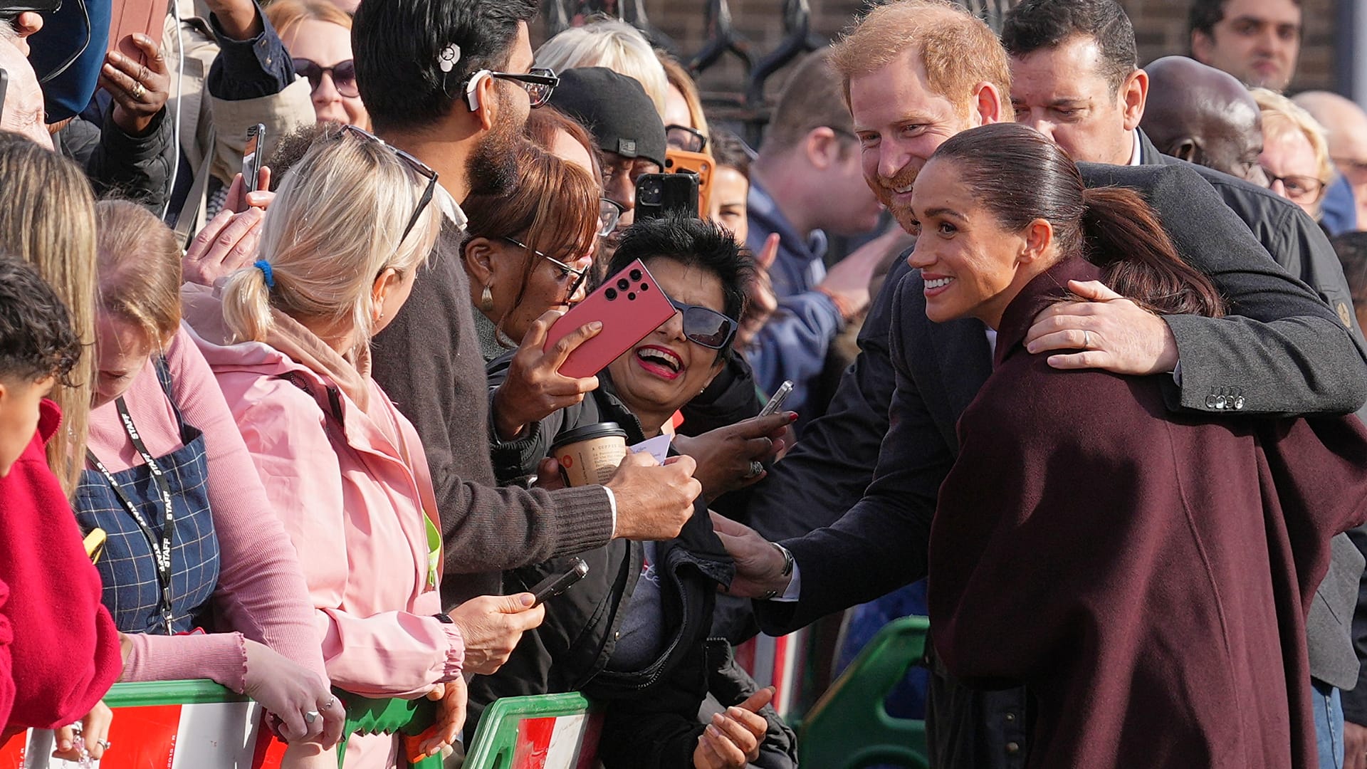Britain's Prince Harry and Meghan, Duke and Duchess of Sussex meet members of the public as they arrive for a visit to The Community Recording Studio in Notting