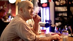 Bar owner Taco smokes a cigarette