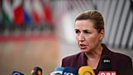 Denmark's Prime Minister Mette Frederiksen speaks with the media as she arrives for the EU summit in Brussels