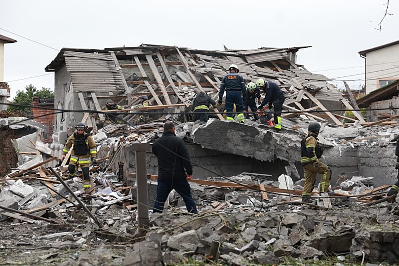 Rescue workers clear the rubble of a residential building destroyed by a Russian airstrike in Zaporizhzhia, 14 October, 2026