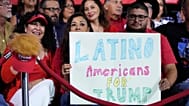 ARCHIVO - Simpatizantes sostienen un cartel durante un acto de campaña, el 12 de septiembre de 2024, en Tucson, Arizona.