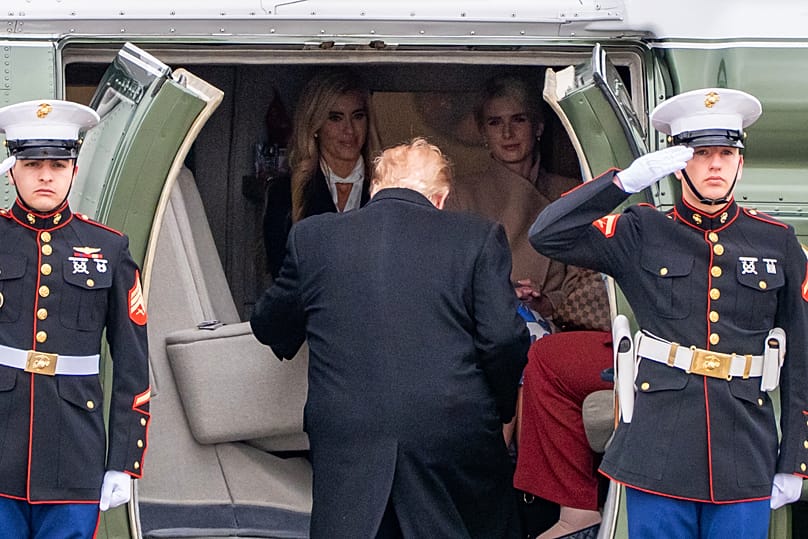  US President Donald Trump boards Marine One as Katie Zacharia and White House aide Natalie Harp look on in Alaska, 13 October 2026.
