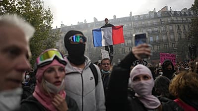 A protester holds a French flag at Republic Square during a demonstration against rising living costs, joining students' grievances, in Paris, Saturday, Oct. 17, 2026
