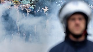 Protesters clash with riot police during a national demonstration against government budget cuts and proposed reforms in Brussels, Belgium, Friday, Oct. 9, 2026. (AP Photo/Gee