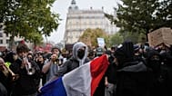 A protesters holds a French flag during a demonstration against rising living costs, joining students' grievances, in Lyon, France, Saturday, Oct. 17, 2026.