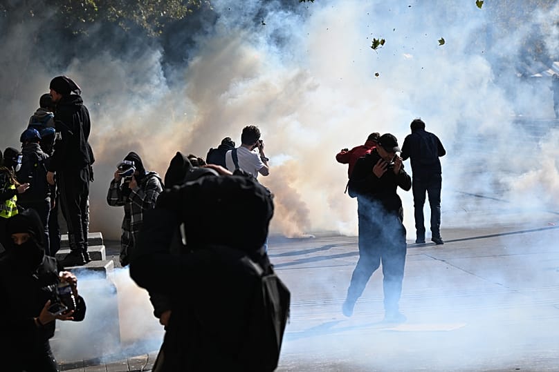 Protesters scuffle with police during a demonstration against rising living costs, joining students' grievances, in Paris, Saturday, Oct. 17, 2026