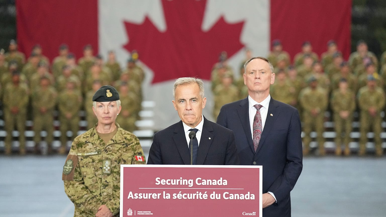 Canada Prime Minister Mark Carney stands with Minister of National Defence David McGuinty, 2025.