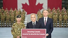 Canada Prime Minister Mark Carney stands with Minister of National Defence David McGuinty, 2025.