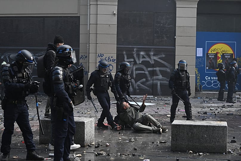 Police detain a protester during a demonstration against rising living costs and students' grievances, in Paris, Saturday, Oct. 17, 2026.