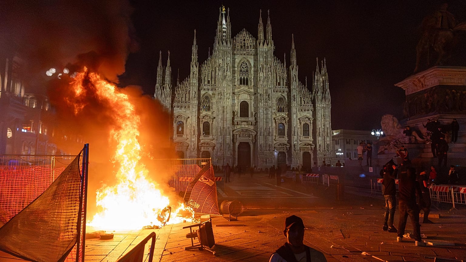 A fire burns following clashes between police and "Italia in Piazza" protesters in front of the Milan Cathedral in Milan, 17 October, 2026