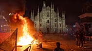 A fire burns following clashes between police and "Italia in Piazza" protesters in front of the Milan Cathedral in Milan, 17 October, 2026