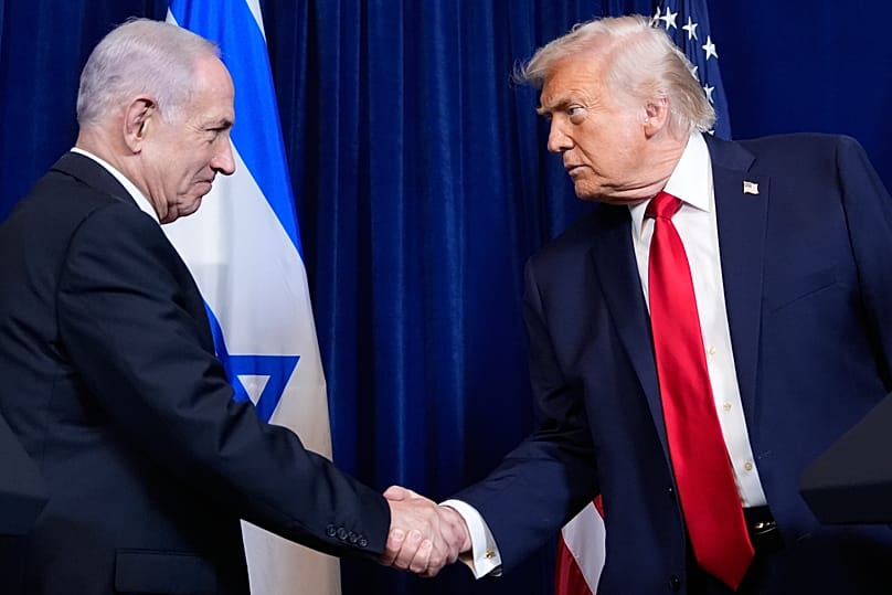 FILE - President Donald Trump shakes hands with Israel's Prime Minister Benjamin Netanyahu during a news conference at Mar-a-Lago, Dec. 29, 2025, in Palm Beach, Fla. (AP Photo