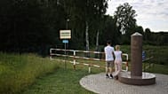 Couple at the point where the borders of Poland, Lithuania and Russia's Kaliningrad region meet, in the town of Zherdziny, Poland.