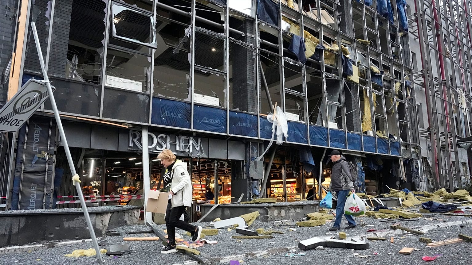 People carry their belongings as they leave their office following Russian air attack in Kyiv, 19 October, 2026