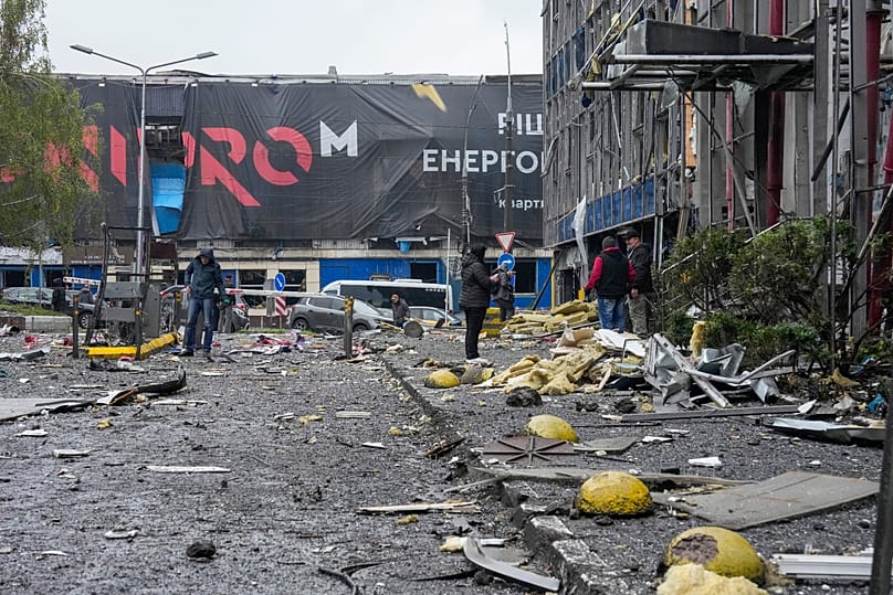 People look at a damaged office centre after a Russian missile attack in central Kyiv, 19 October, 2026