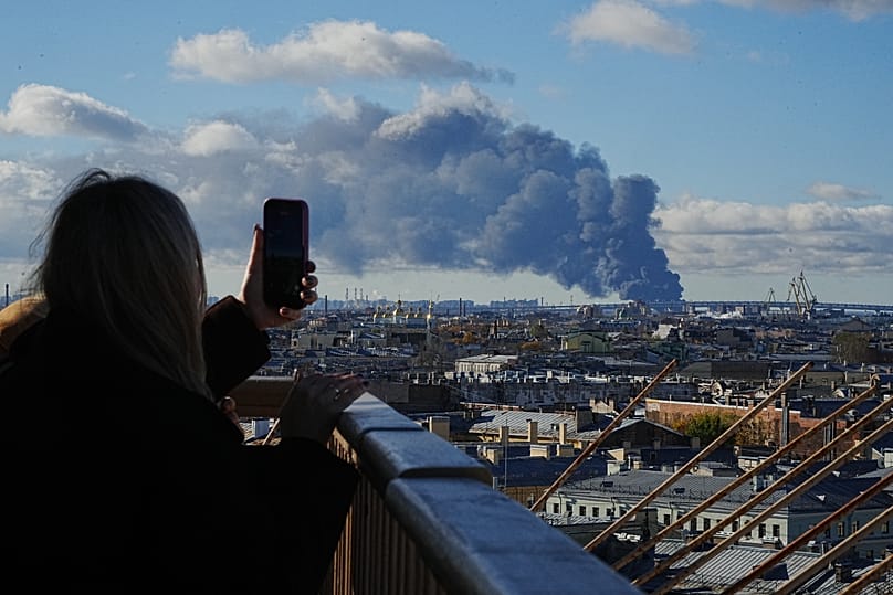 Smoke billows into the sky following Ukrainian drone strikes on an industrial zone in St. Petersburg, Russia, on Sunday, Oct. 18, 2026.