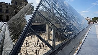 Visitors walks inside the pyramid during the reopening to the public of the Apollo Gallery at the Louvre museum in Paris, 22 July, 2026