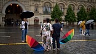 FILE: Tourists pose for a photo with their umbrellas in the rain at Red Square in Moscow, 14 June 2026