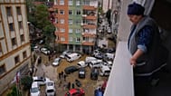 Local residents walk among toppled vehicles and scattered debris in the aftermath of floods caused by heavy rains in Istanbul, 15 October, 2026